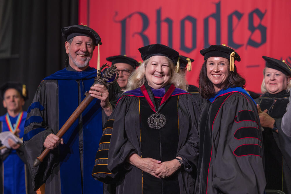 a man and two women in academic robes