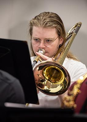 a young man playing a horn