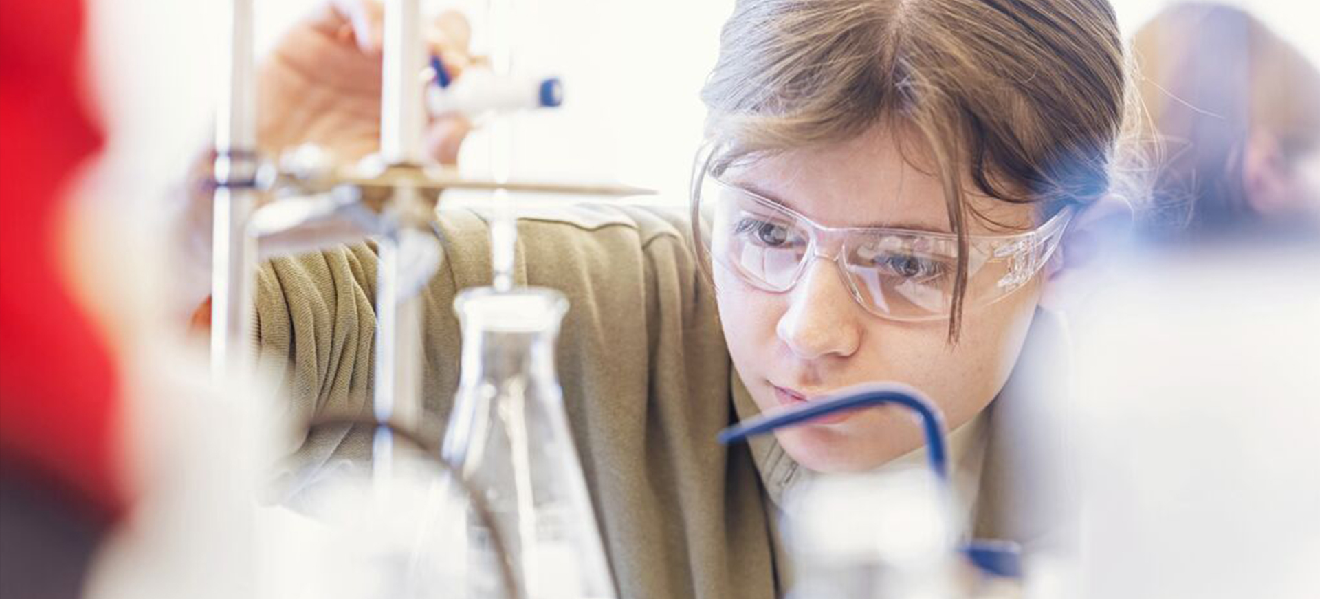 a young woman measure a liquid in a beaker