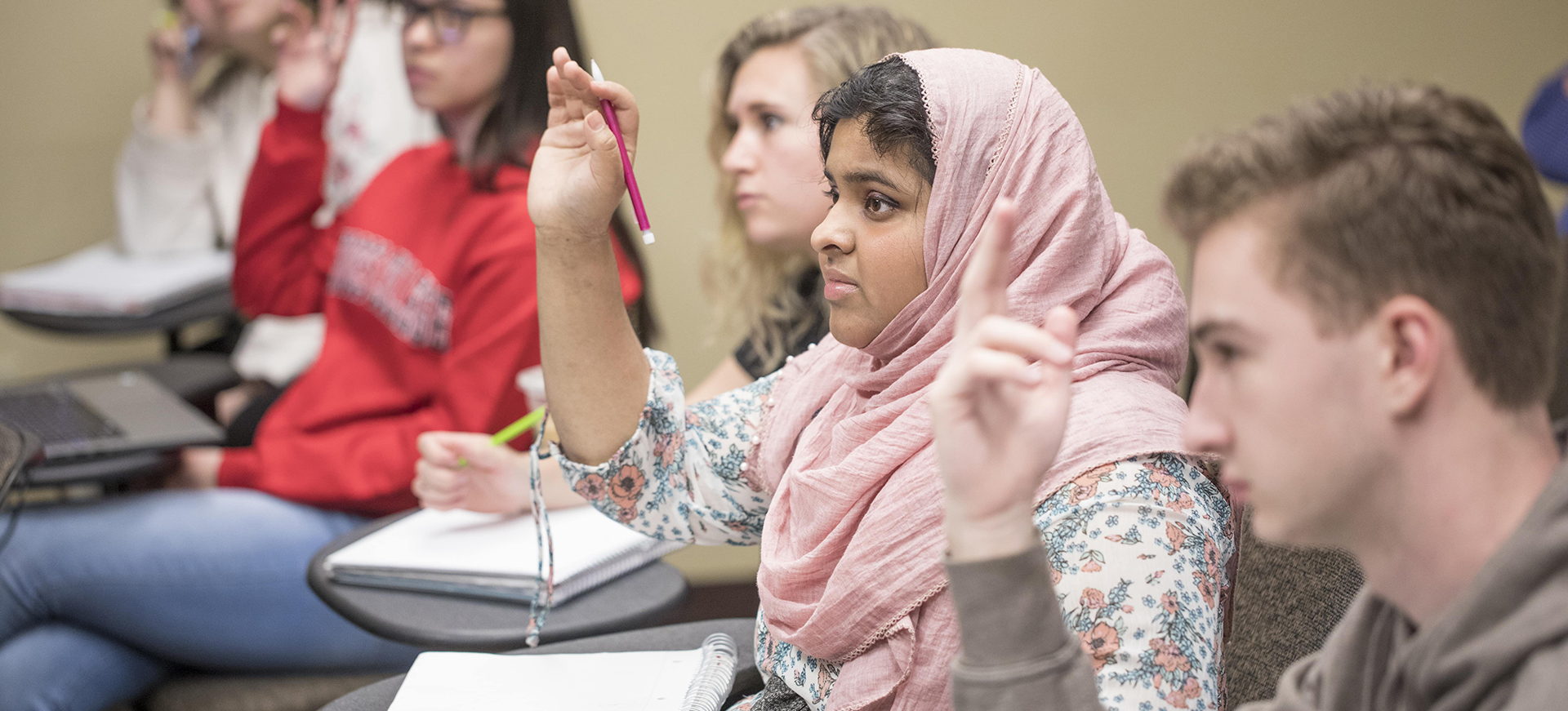 a student raises her hand in class