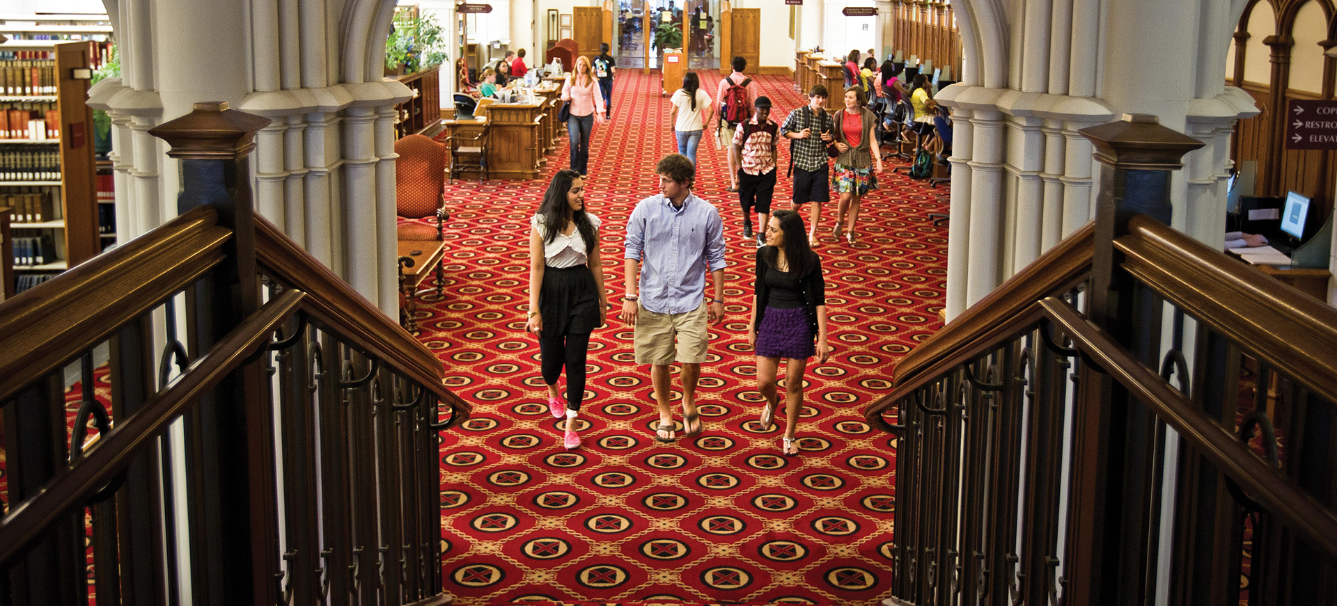 students walking in the library