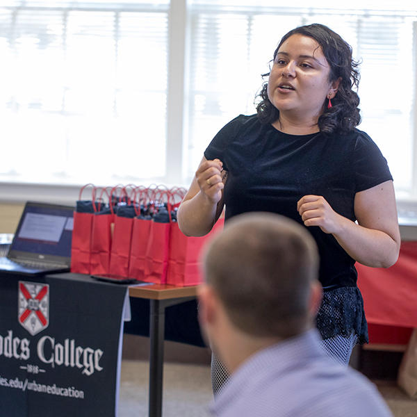 A female student speaking at orientation for the master's program