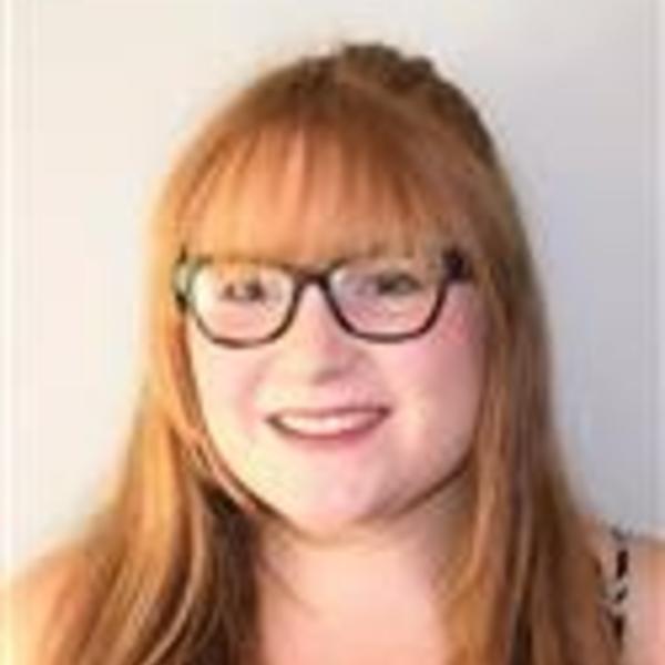 a female student with glasses and red hair