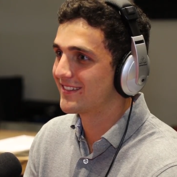 A young man wearing headphones in a recording studio.