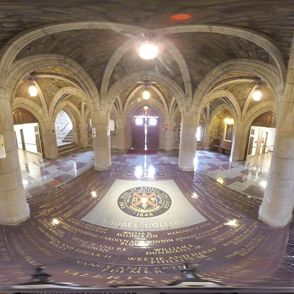 a wide-angle shot of a cloister surrounded by granite arched columns