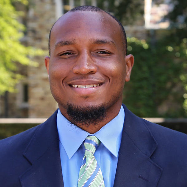 a young African American man in a blue suit