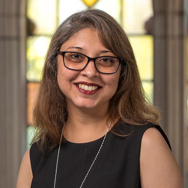 a woman with glasses and shoulder length brown hair
