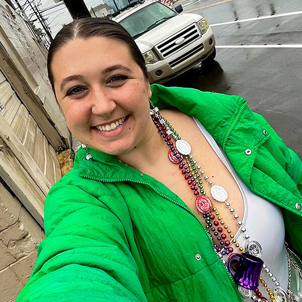 a woman in Mardi Gras beads