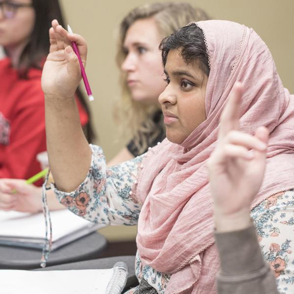 a student raises her hand in class