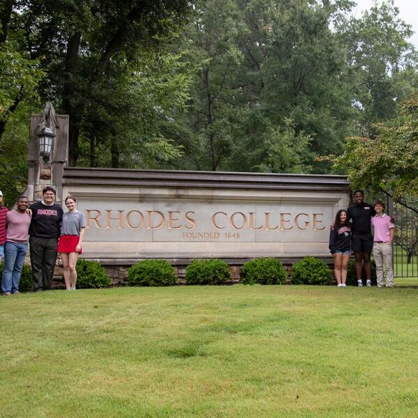 Students in front of Rhodes sign