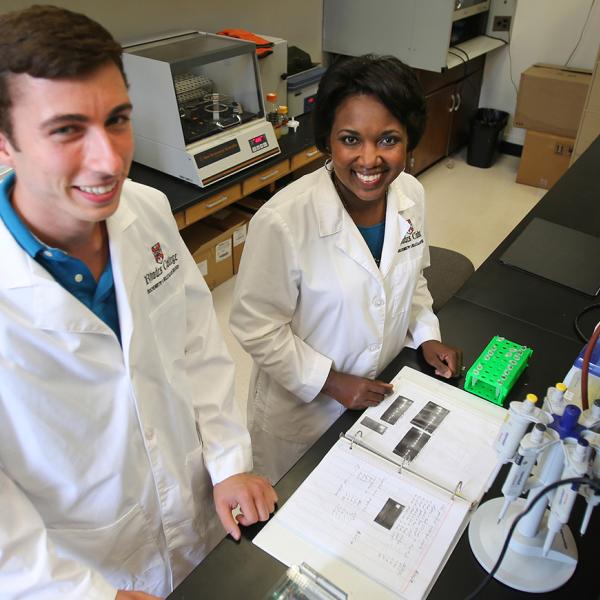 a student and professor in a lab