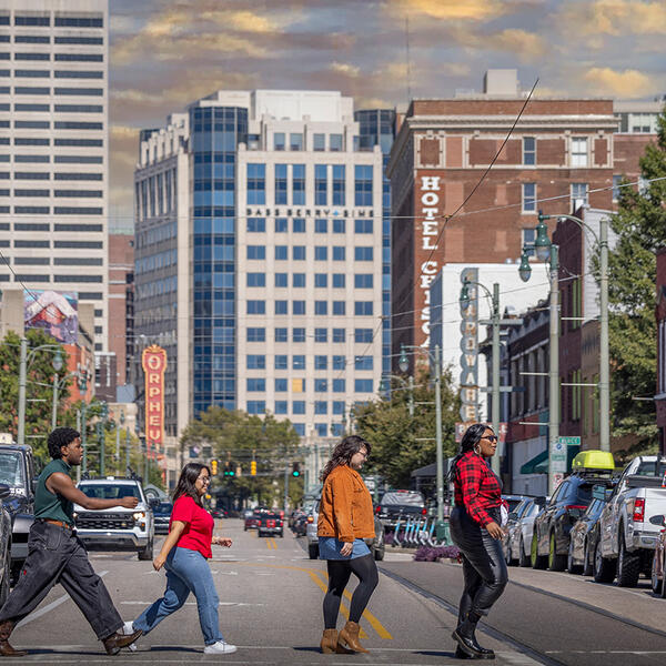 students cross a downtown street