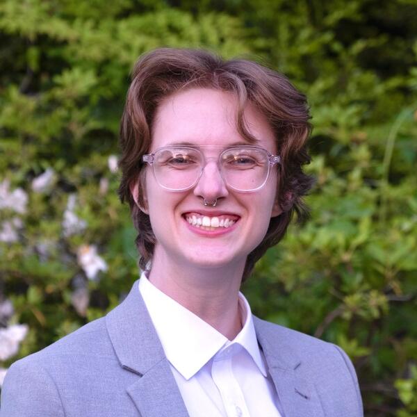 a woman with short hair and glasses