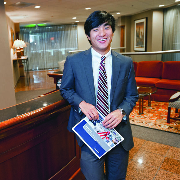 Student wearing a suit in a professional office