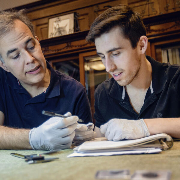 a professor and a student examining an artifact
