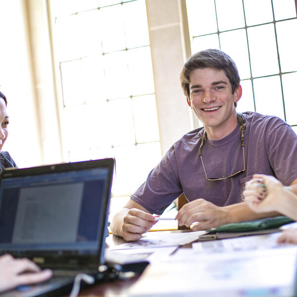 a group of students talking around a table
