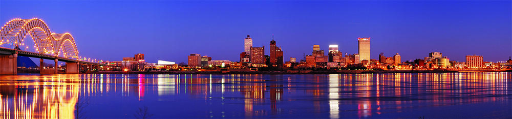 The skyline of downtown Memphis looking back from the middle of the river at dusk.