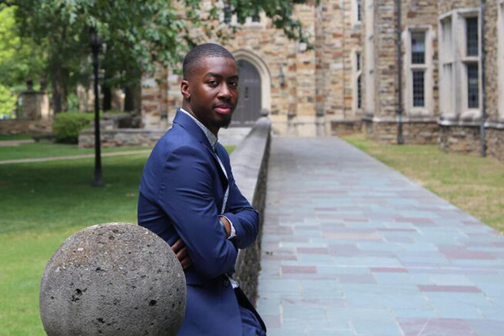a young African American man on a Collegiate Gothic campus