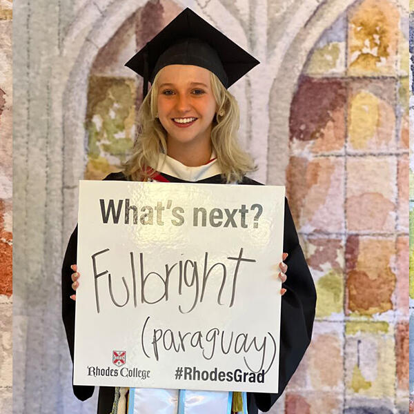 a student holds a sign that says Fulbright