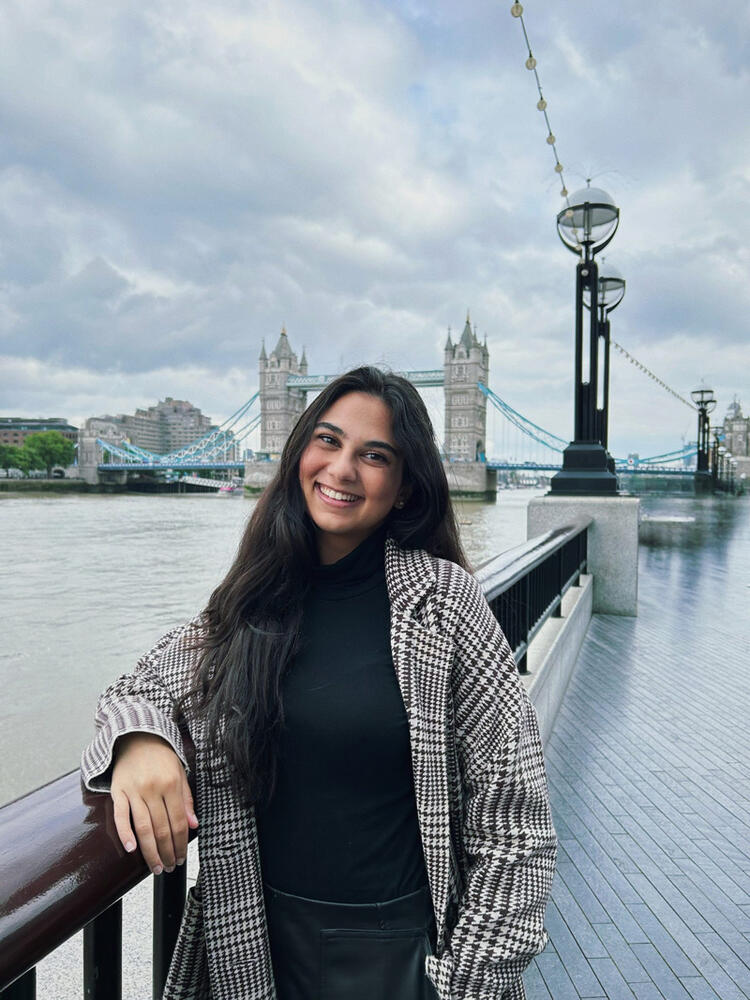 a young woman stands on a bridge in London