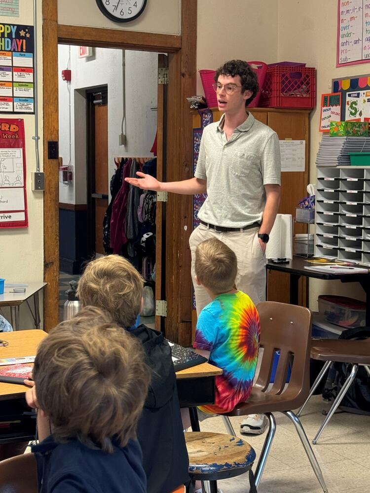 Jack Sullivan in front of a children's classroom