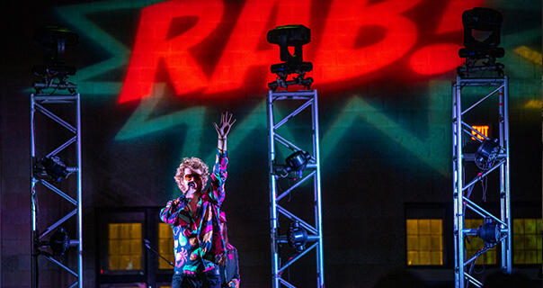 a young man performs on a stage 