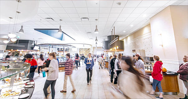  a large refectory with people choosing dining options