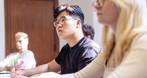 a young man listens in class